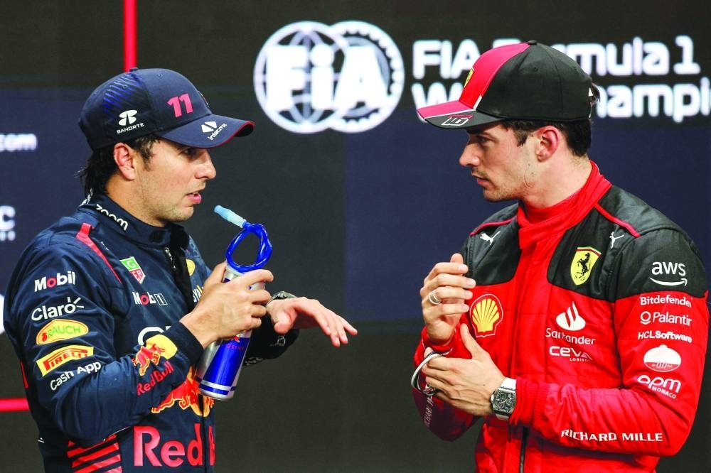 Pole position winner Red Bull Racing’s Mexican driver Sergio Perez (left) chats with second-placed Ferrari’s Monegasque driver Charles Leclerc at the end of the qualifying session of the Saudi Arabia Grand Prix at the Corniche Circuit in Jeddah yesterday. (AFP)