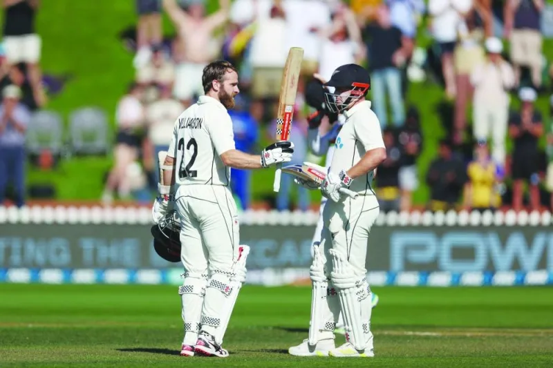 New Zealand’s Kane Williamson (left) celebrates 200 runs with teammate Henry Nicholls on day two of the second Test against Sri Lanka at the Basin Reserve in Wellington yesterday. (AFP)