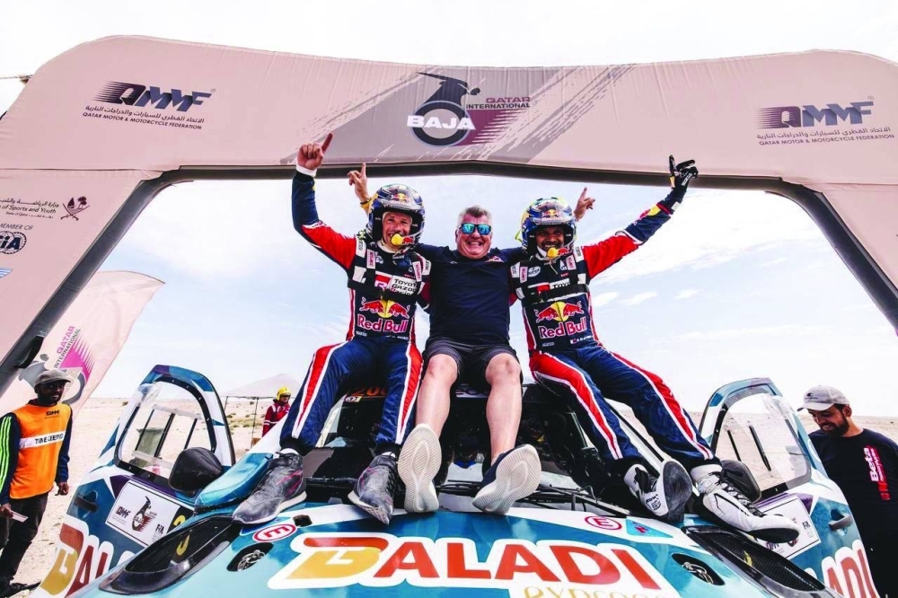 Qatar’s Nasser Saleh al-Attiyah and his French co-driver Mathieu Baumel celebrate victory in the car category at the end of a pulsating Qatar International Baja which concluded on Saturday. 