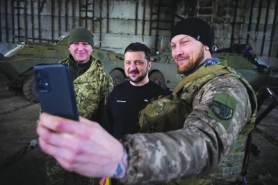 President Volodymyr Zelensky (centre) taking a selfie with servicemen after meeting them in a warehouse and handing out awards near Bakhmut. (AFP)