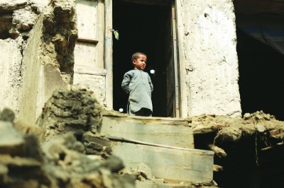 A boy looks out from his damaged home in Miya village, in Alishing District of Laghman Province yesterday following an overnight earthquake. (AFP)