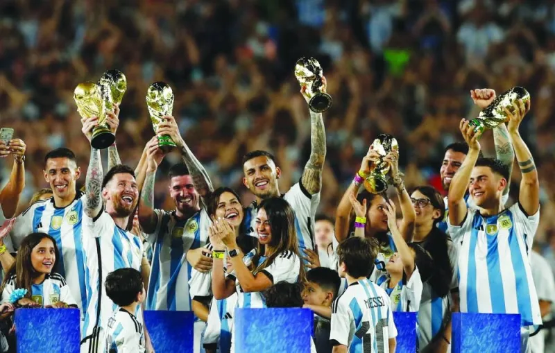 Argentina’s Lionel Messi and teammates celebrate with their families and World Cup trophies after the friendly against and Panama at Monumental Stadium in Buenos Aires. (Reuters)