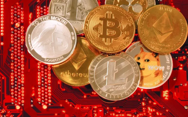 FILE PHOTO: Representations of cryptocurrencies Bitcoin, Ethereum, DogeCoin, Ripple, Litecoin are placed on PC motherboard in this illustration taken, June 29, 2021. REUTERS/Dado Ruvic/Illustration