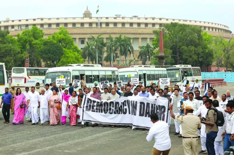 India’s Congress Party president Mallikarjun Kharge (centre) along with members of parliament (MP) of various opposition parties take part in a protest march towards the  Rashtrapati Bhawan, against conviction of Congress Party member — Rahul Gandhi in a criminal defamation case during a demonstration in New Delhi on Friday. 