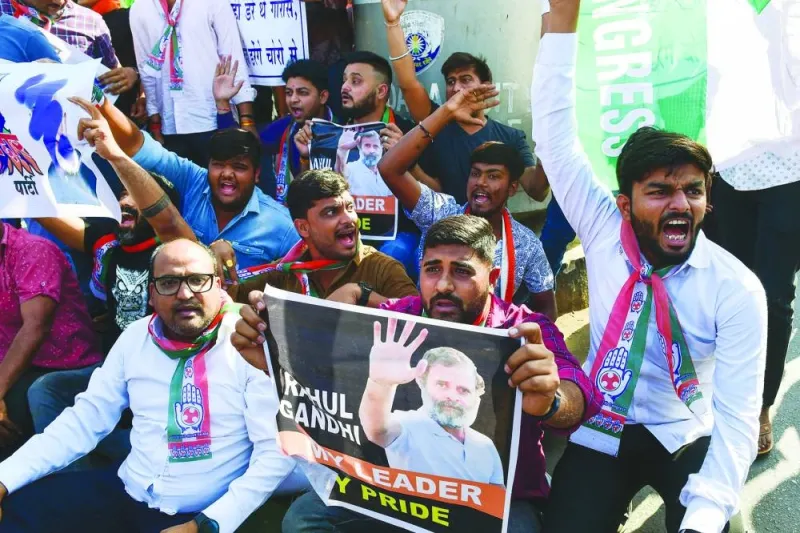 India’s Congress Party activists and supporters protest against conviction of party leader Rahul Gandhi in a criminal defamation case, in Ahmedabad, on Saturday.