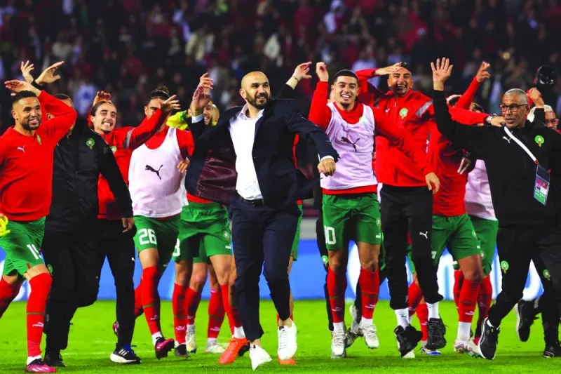 Morocco’s coach Walid Regragui (centre) and his players greet the fans after the friendly match against Brazil at the Ibn Batouta Stadium in Tangier on Saturday. (AFP)