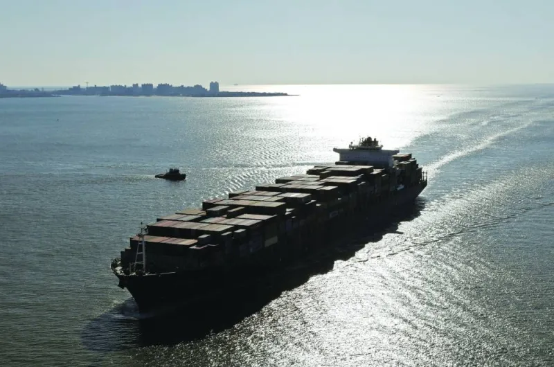 A container ship sails into the New York Harbor (file). Presenting their annual trade forecast, WTO economists said they expected to see the volume of global merchandise trade slow to 1.7% this year — a full percentage point lower than in 2022.