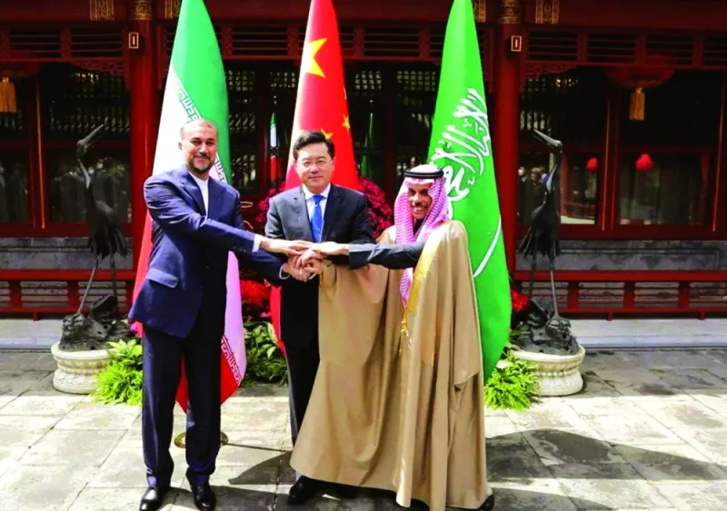 Iran’s Foreign Minister Hossein Amir-Abdollahian with Saudi Arabia’s Foreign Minister Prince Faisal bin Farhan al-Saud and Chinese Foreign Minister Qin Gang shake hands in Beijing.
