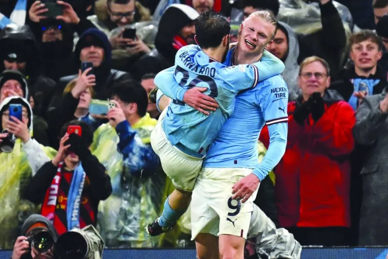 Manchester City’s Erling Haaland (right) celebrates with teammate Bernardo Silva after scoring against Bayern Munich during the 
Champions League first leg quarter-final on Tuesday. (AFP)