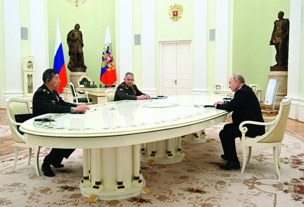 Russian President Vladimir Putin, Defence Minister Sergei Shoigu and Chinese Defence Minister Li Shangfu attend a meeting in Moscow yesterday.