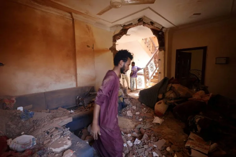 A man looks at the damage inside a house during clashes between the paramilitary Rapid Support Forces and the army in Khartoum, Sudan. REUTERS