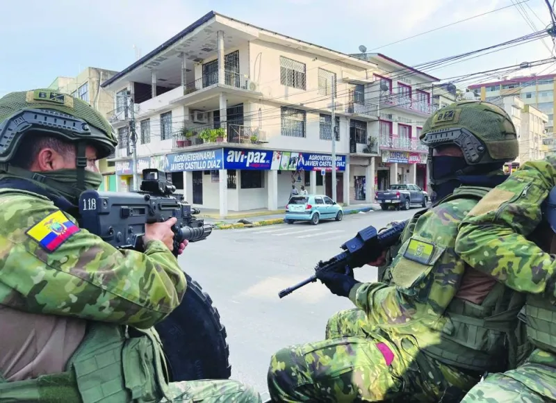 Ecuadorean soldiers and police officers take part in a security operation at the Rivera del Rio neighbourhood in Esmeraldas.