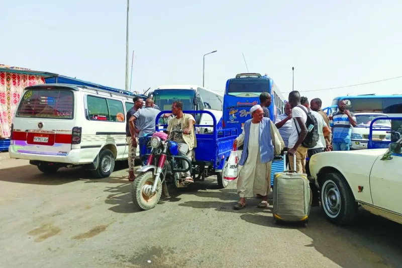 Passengers fleeing war-torn Sudan disembark at the Wadi Karkar bus station near the Egyptian city of Aswan, yesterday.
