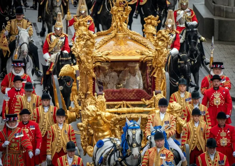 King Charles III and Queen Camilla are carried in the Gold State Coach, pulled by eight Windsor Greys, in the Coronation Procession as they return along Whitehall to Buckingham Palace, London, following their coronation ceremony. REUTERS