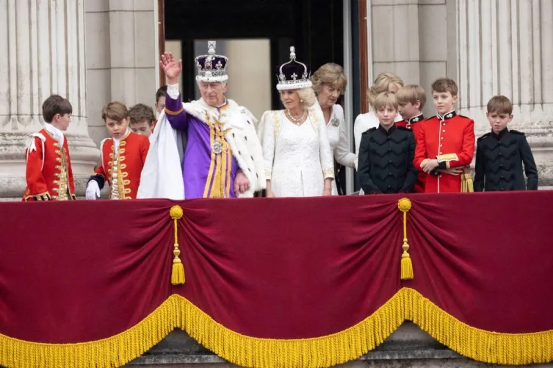 Britain&#039;s King Charles and Queen Camilla stand on the Buckingham Palace balcony following their coronation ceremony. REUTERS