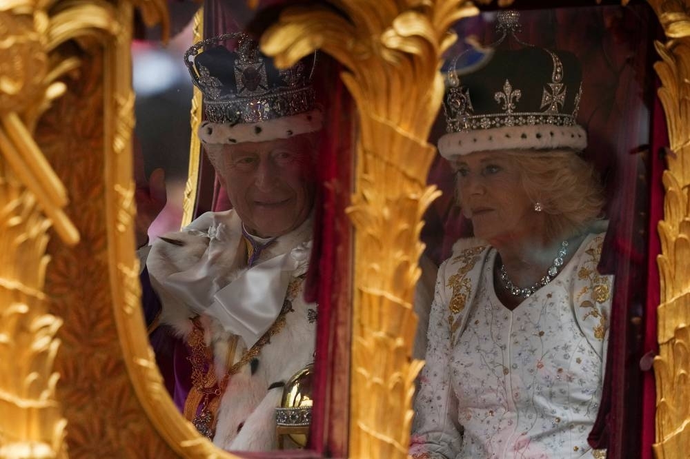 Britain&#039;s King Charles and Queen Camilla travel, following their coronation ceremony, in London. REUTERS