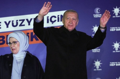 Turkish President Tayyip Erdogan (R), accompanied by his wife Ermine Erdogan (L), waves to supporters at the AK Party headquarters in Ankara. Adem Altan / AFP
