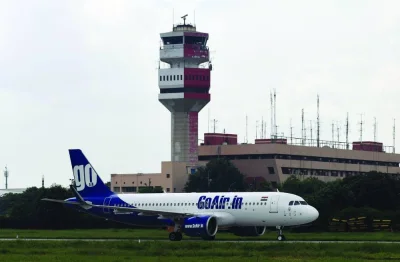 A GoAir plane taxis past a control tower at Indira Gandhi International Airport in New Delhi. Go First airline has entered voluntary bankruptcy, due partly to long-running fleet problems that are out of its control. Another airline Spicejet is mired in court disputes as aircraft lessors seek unpaid fees, and Jet Airways faces looming deadlines to keep its relaunch hopes alive.