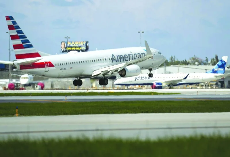 
An American Airlines plane lands on a runway near a parked JetBlue plane at the Fort Lauderdale-Hollywood 
International Airport in Florida. American Airlines and JetBlue Airways Corp must dissolve a partnership covering flights across the northeastern US, after a federal judge agreed with antitrust enforcers that the alliance would reduce 
competition and boost fares for consumers. 
