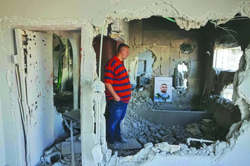 A man inspects the house of Palestinian fighter Mutaz Khawaja, after it was razed by Israeli security forces in the West Bank village of Nilin, on Tuesday.
