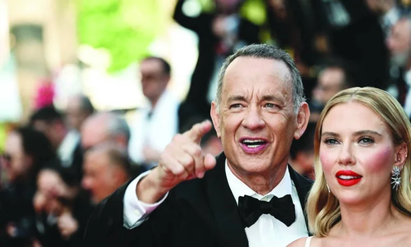 US actor Tom Hanks (left) and US actress Scarlett Johansson arrive for the screening of the film Asteroid City during the 76th edition of the Cannes Film Festival in Cannes on Tuesday. ( AFP)