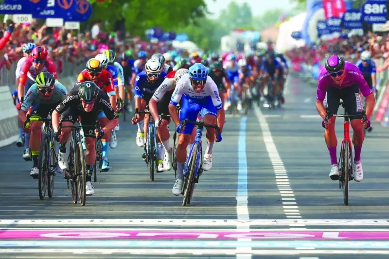 Team DSM’s Italian rider Alberto Dainese (second left) sprints to the finish line to win the 17th stage ahead of Bahrain - Victorious’s Italian rider Jonathan Milan (right) and Team Jayco AlUla’s Australian rider Michael Matthews (second right) during the Giro d’Italia 2023 cycling race, after covering a distance of 197km between Pergine Valsugana and Caorle, near Venice, on Wednesday. (AFP)