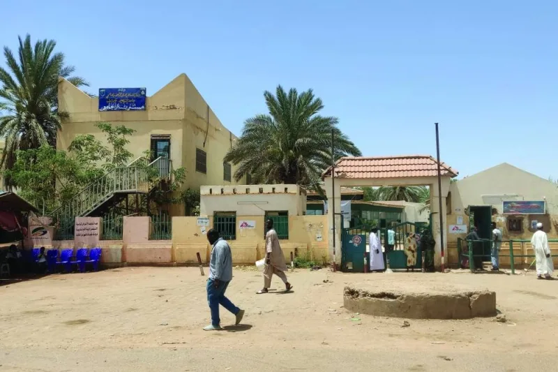 Sudanese walk outside Bashir hospital in Khartoum on Friday, as fighting eased following a ceasefire.