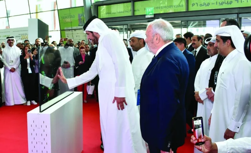 HE Sheikh Mohamed bin Hamad bin Qassim al-Abdullah al-Thani using a high-tech screen to officially open the 19th edition of Project Qatar at DECC Monday. PICTURE: Thajudheen