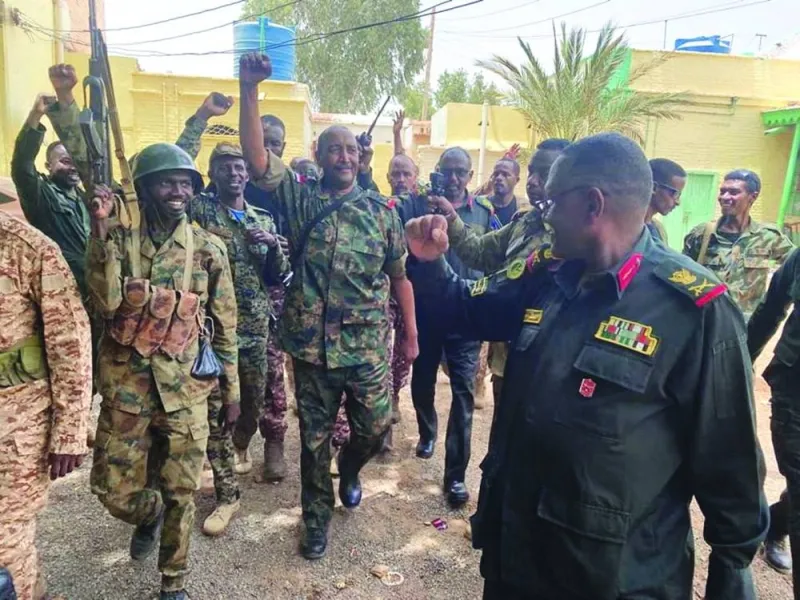 
Sudan’s General Abdel Fattah al-Burhan walks with troops, in an unknown location, in this picture released yesterday. 