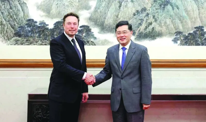 
Tesla CEO Elon Musk (left) shaking hands with China’s Foreign Minister Qin Gang during a meeting in Beijing. (AFP) 