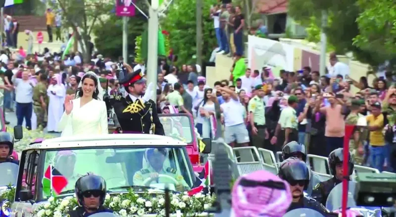
The convoy carrying Crown Prince Hussein and Rajwa al-Saif leaves after their royal wedding ceremony in Amman. 
