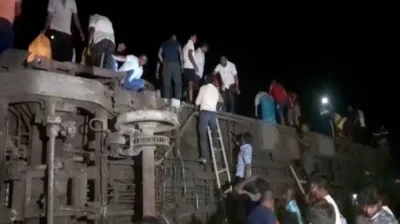 People try to escape from toppled compartments, following the deadly collision of two trains, in Balasore in this screen grab obtained from a video. ANI/Reuters TV via REUTERS.