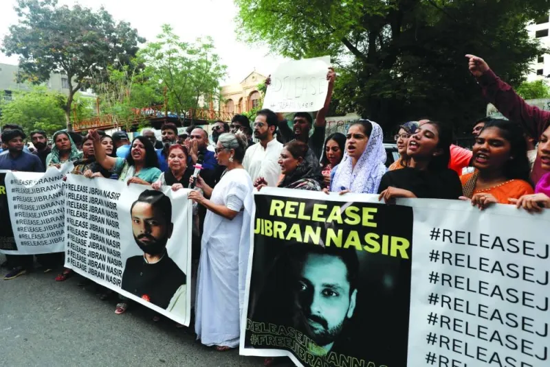 People chant slogans while carrying banners to demand the release of human rights activist and lawyer Jibran Nasir, during a protest in Karachi.
