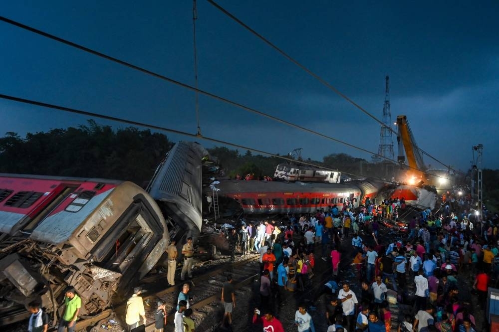 Rescue workers recover victims&#039; bodies from a carriage wreckage of a three-train collision near Balasore, in India&#039;s eastern state of Odisha. DIBYANGSHU SARKAR / AFP