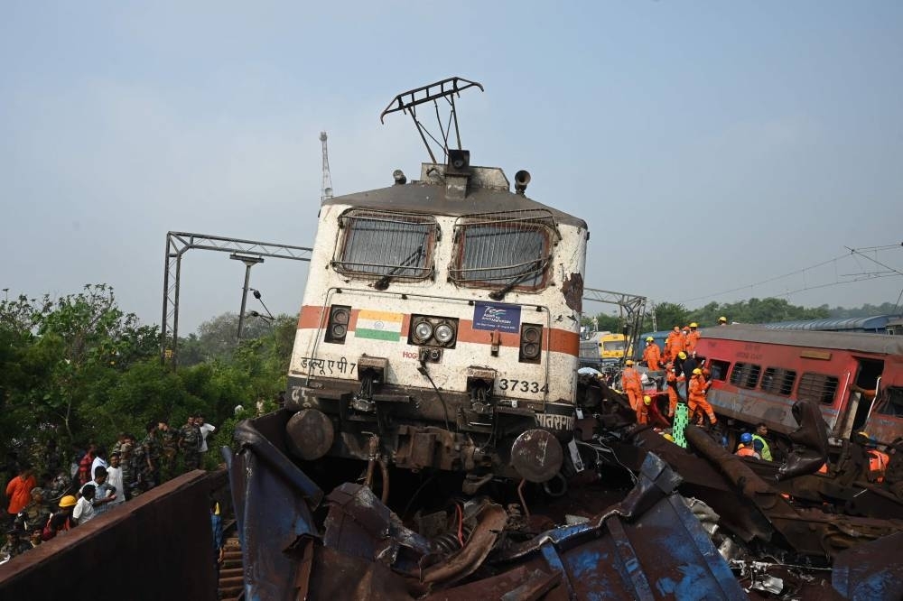 Rescue workers and military personnel gather around damaged carriages at the accident site of a three-train collision near Balasore, about 200 km from the state capital Bhubaneswar in the eastern state of Odisha. DIBYANGSHU SARKAR / AFP
