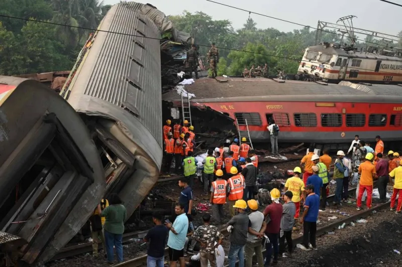 Rescue workers gather around damaged carriages at the accident site of a three-train collision near Balasore, about 200 km from the state capital Bhubaneswar in the eastern state of Odisha. DIBYANGSHU SARKAR / AFP