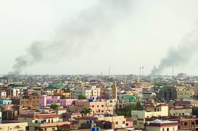 Smoke billows behind buildings in Khartoum, on Sunday.