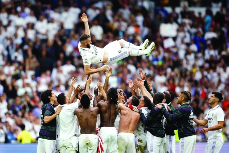 
Real Madrid players throw Karim Benzema in the air after the striker played the final match for the La Liga giants on Sunday. Benzema is tipped to join Saudi side Al Ittihad. (Reuters) 