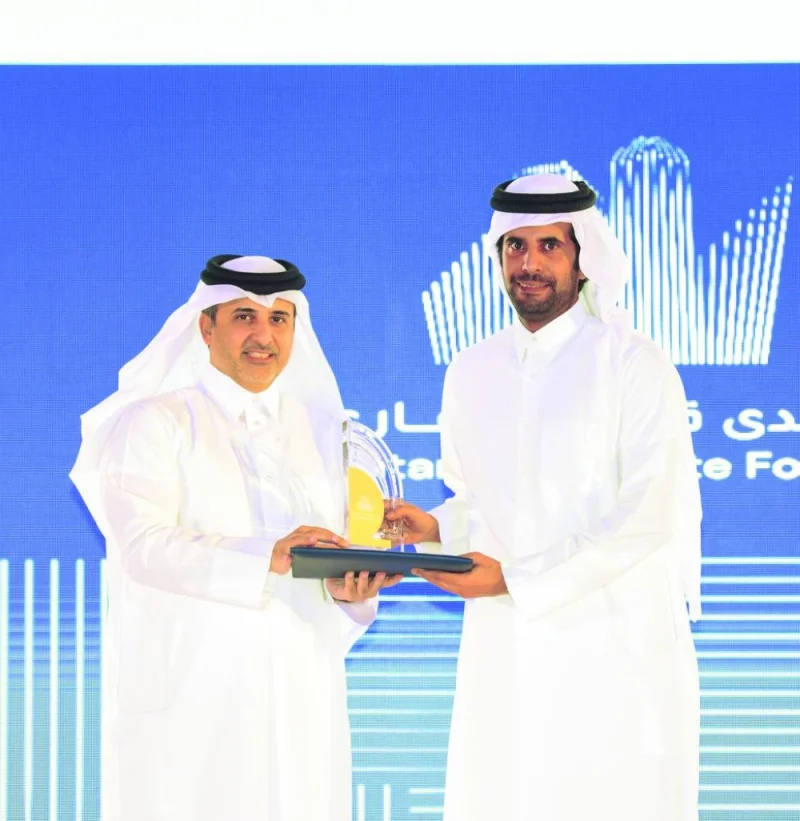 HE the Minister of Municipality Dr Abdullah bin Abdulaziz bin Turki al-Subaie presenting a memento to a GWC official at the conclusion of Qatar Real Estate Forum.