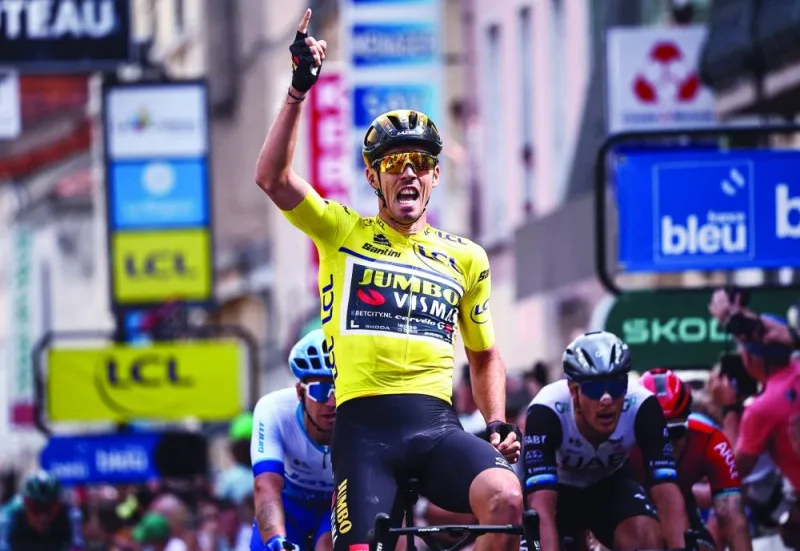 French rider Christophe Laporte celebrates as he crosses the finish line to win the third stage of the 75th edition of the Criterium du Dauphine in Le Coteau, France, on Tuesday. (AFP)