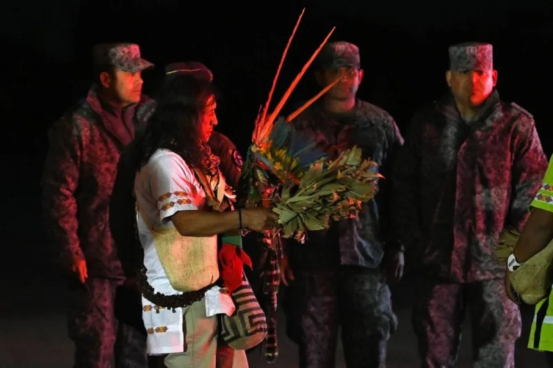 An Indigenous man who took part with the military in the search of the four Indigenous children who were found alive after being lost for 40 days in the Colombian Amazon forest following a plane crash, descends from a plane before the children are taken into ambulances upon landing at the CATAM military base in Bogota. AFP