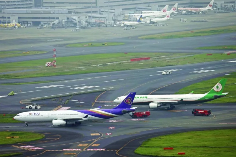 
An aerial view shows Thai Airways and Eva Air aeroplanes on a taxiway after making contact at Tokyo’s Haneda Airport. 