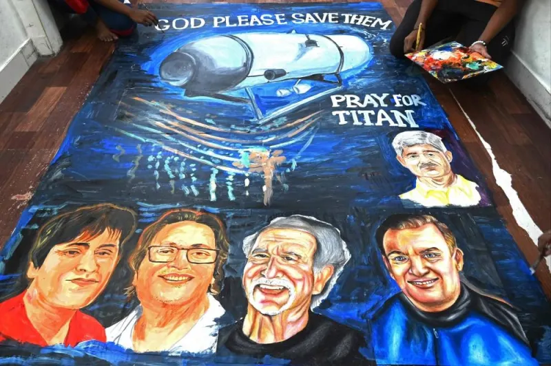 Art school students in Mumbai on June 22 give final touches to a painting depicting five people aboard  a submersible named Titan, that went missing near the wreck of the Titanic. INDRANIL MUKHERJEE / AFP