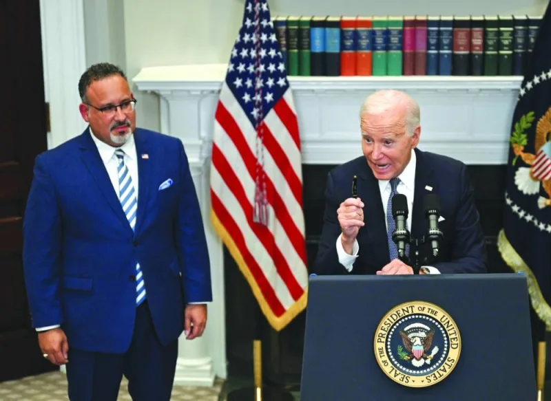 
Biden speaks about the US Supreme Court’s decision overruling student debt forgiveness in the Roosevelt Room of the White House in Washington, DC. With him is Education Secretary Miguel Cardona. 