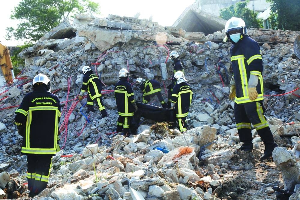 
Rescue workers search in the rubble of a collapsed building in Abidjan. 