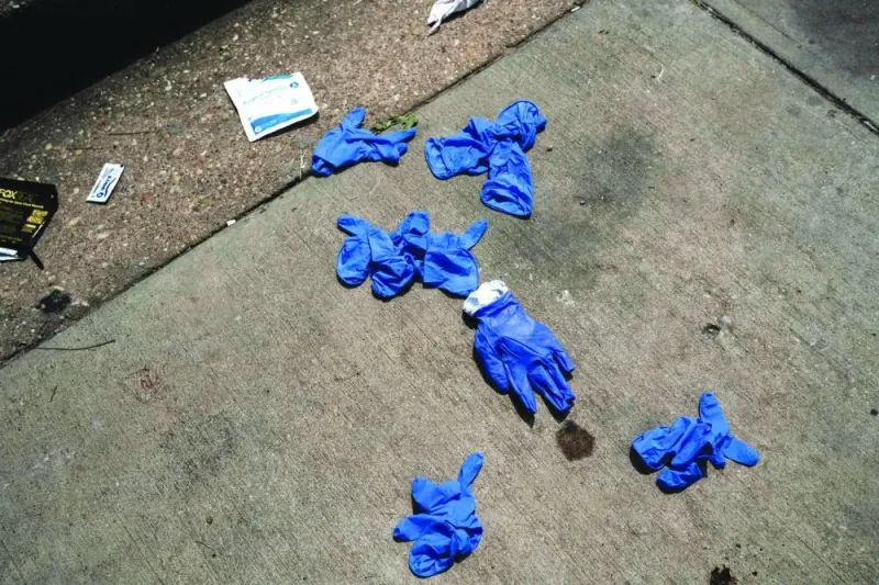 Gloves and other medical supplies are seen at the site of a mass shooting in Brooklyn Homes.