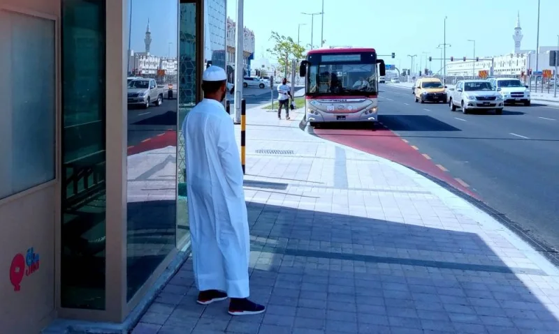 A passenger waits in front of an air-conditioned bus shelter as another is about to enter a metrolink bus in a Doha locality. PICTURE: Thajudheen.