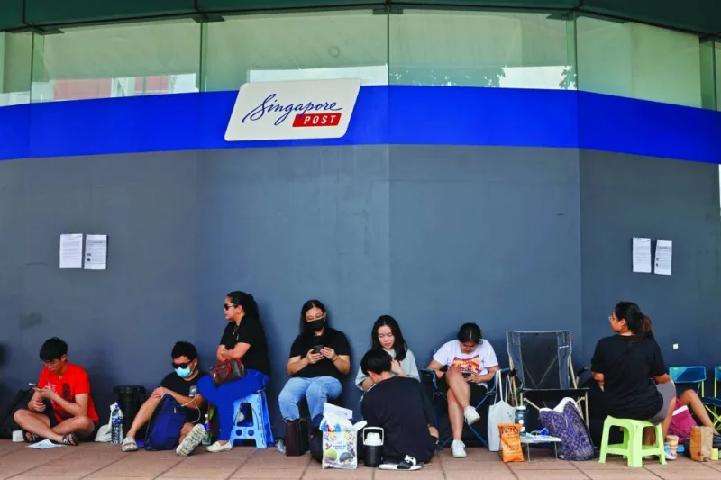 People queue to buy Taylor Swift concert tickets outside a post office in Singapore, on Friday.