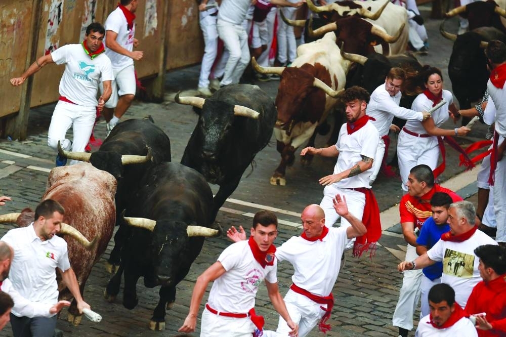 
Participants run yesterday ahead of bulls during the ‘encierro’ (bull-run) of the San Fermin festival in Pamplona. 