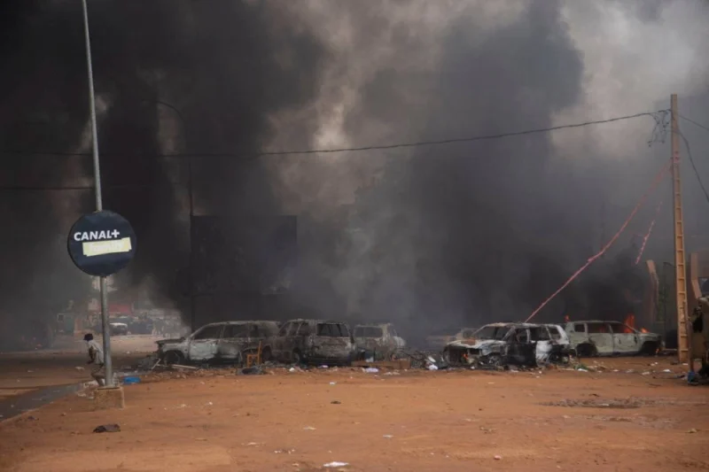 Supporters of the coup set fire to ruling party HQ while  hundreds of them gather in front of the National Assembly in the capital Niamey, Niger July 27. REUTERS